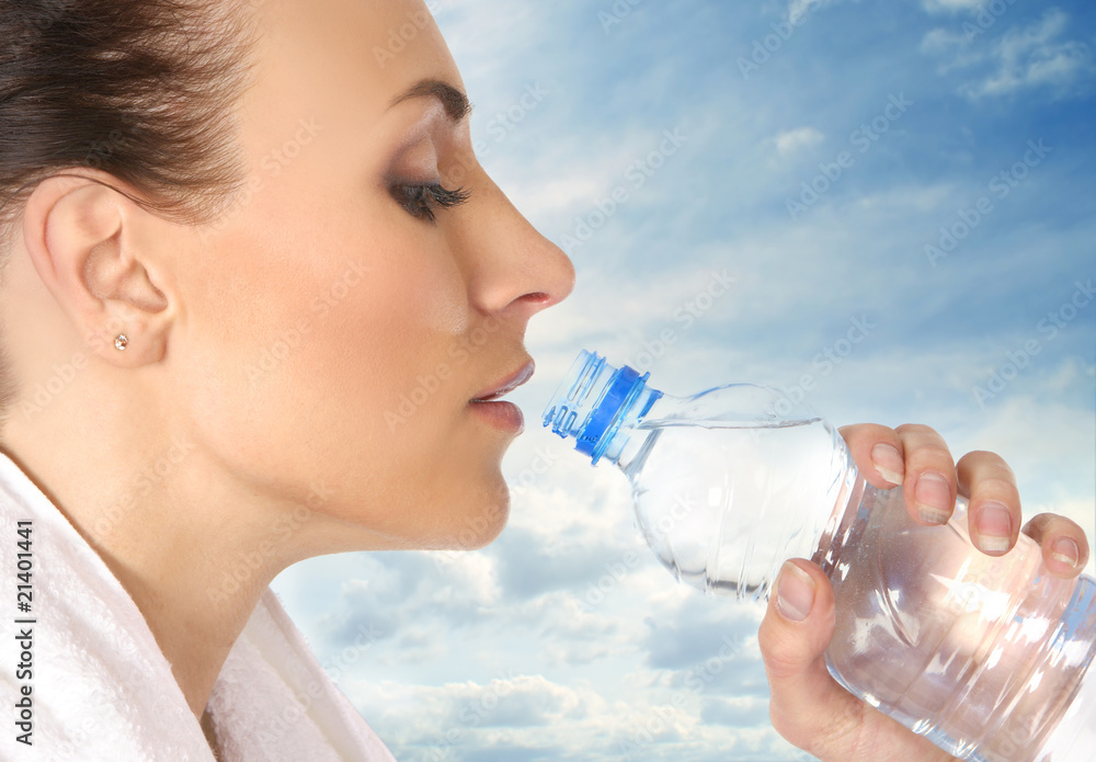 Young and attractive female sportsman drinking water Young and attractive female sportsman drinking water