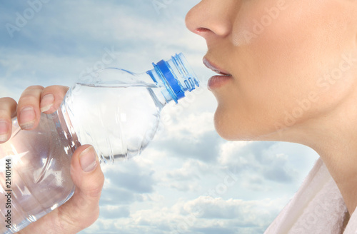 Young and attractive female drinking water