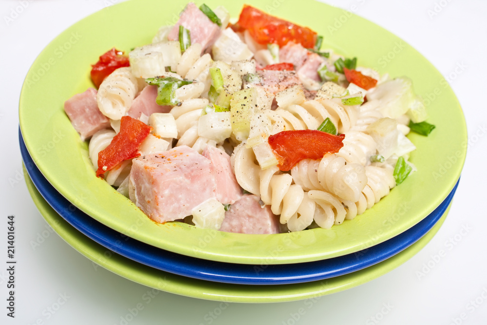 Serving of pasta, turkey, celery and fried tomatoes salad Serving of pasta, turkey, celery and fried tomatoes salad