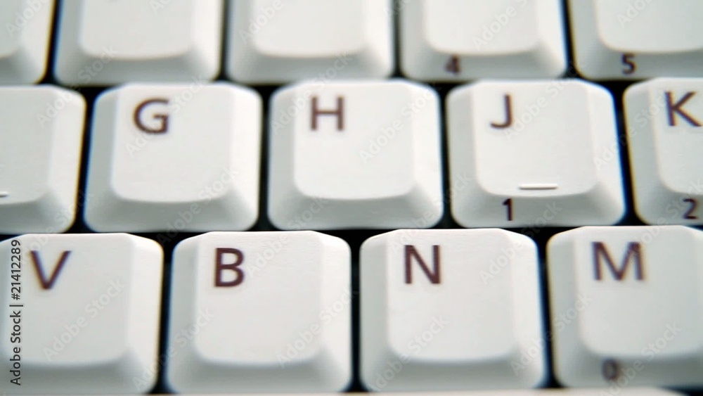 Selective focused track shot of a white keyboard. Selective focused track shot of a white keyboard.