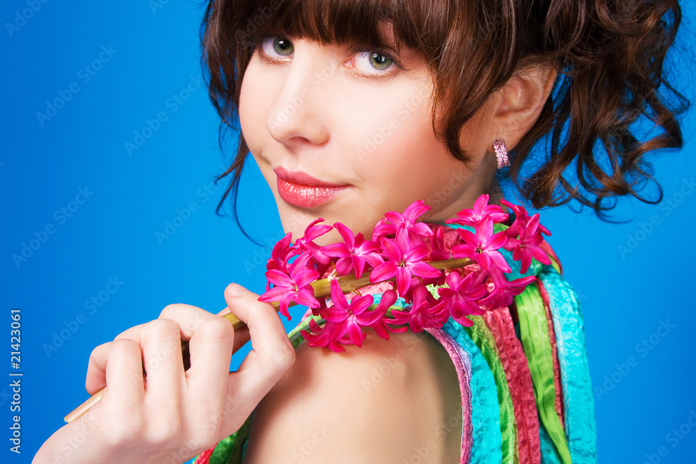 Fototapeta premium Pretty brunette with a pink flower