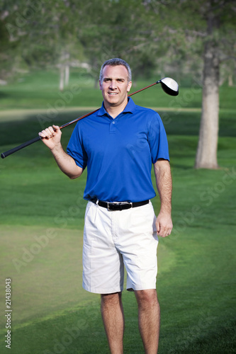A handsome mature male golfer in his 40s-50s on the golf course