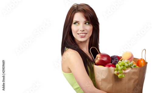 woman holding a  bag full of fresh and healthy food. © ZoomTeam