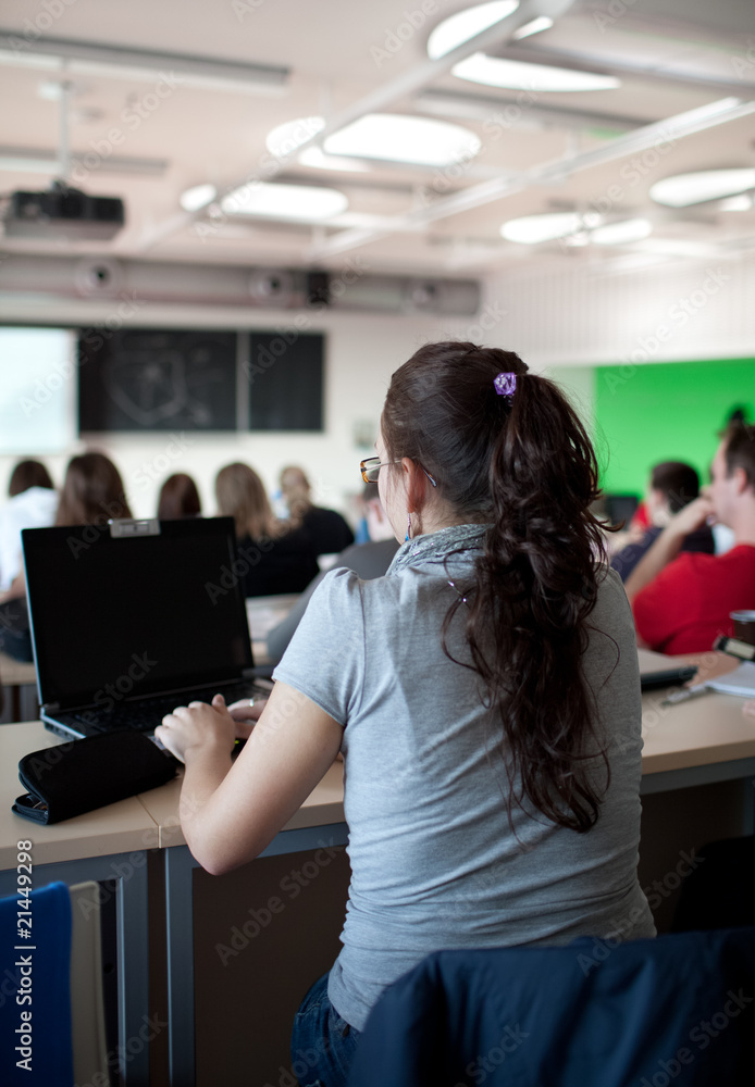 young pretty female college student sitting in a classroom full young pretty female college student sitting in a classroom full