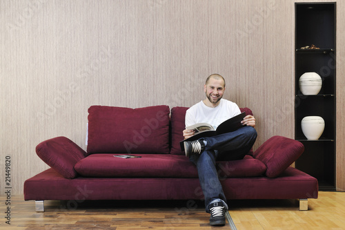 happy young man realxing in modern living room photo