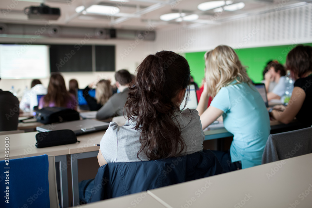 young pretty female college student sitting in a classroom full young pretty female college student sitting in a classroom full