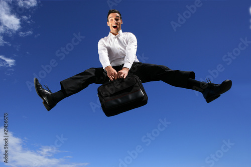 Schilderij op canvas Homme d'affaires sautant dans les airs