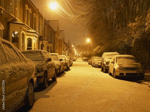 Snowy residential street at night