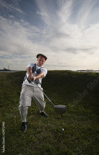 Golfer missing the ball in the rough.