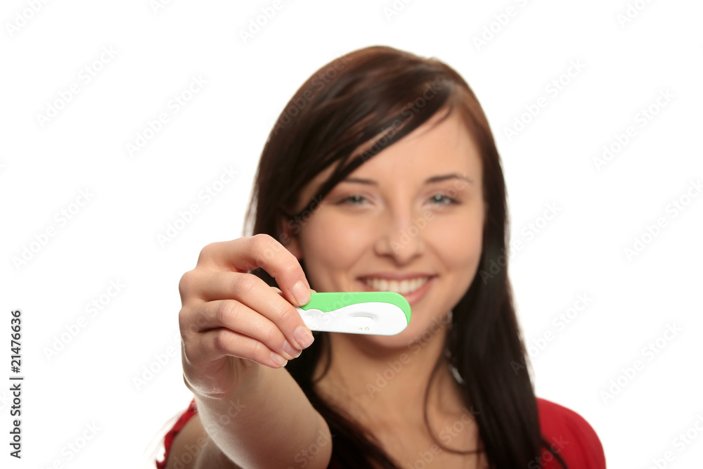 Smiling woman holding a pregnancy test Smiling woman holding a pregnancy test