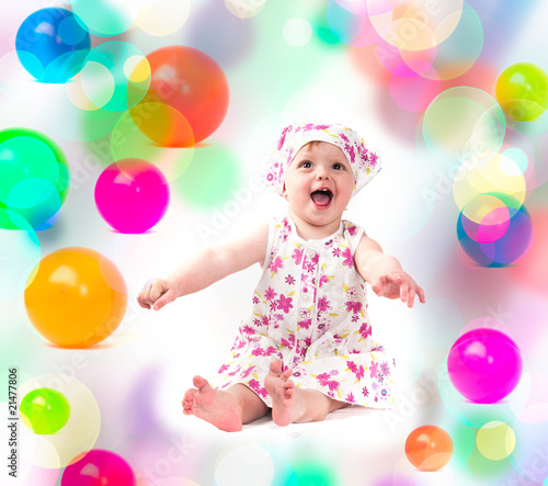 baby playing with colorful balloons