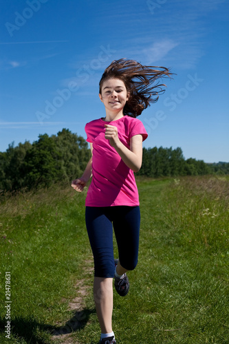 Girl jumping, running against blue sky © Jacek Chabraszewski