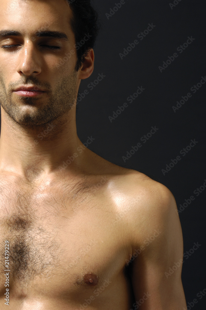 Close up young sensual man on a black