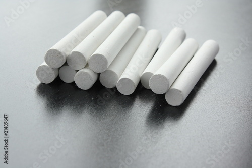 unused white chalks on anew blackboard
