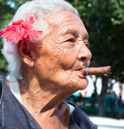 Old wrinkled woman smoking cigar