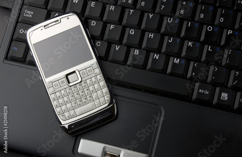Mobile phone on a laptop keyboard