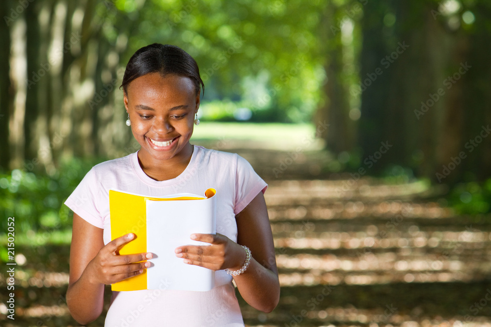 happy african american uni student reading on campus happy african american uni student reading on campus