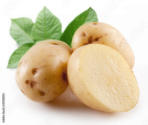 Yellow potatoes with leaves on a white background
