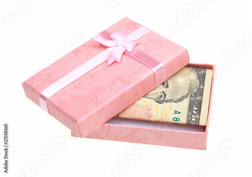 Beautiful pink gift with money anknotes isolated on white photo