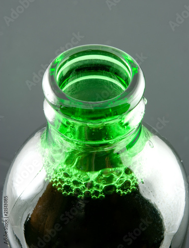 open green beer bottle close-up photo