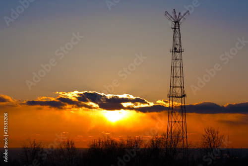 Communication tower against sunset background