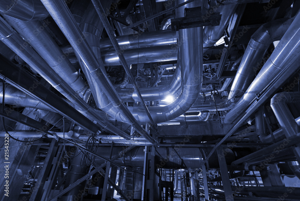 Pipes, tubes, machinery and steam turbine at a power plant in bl