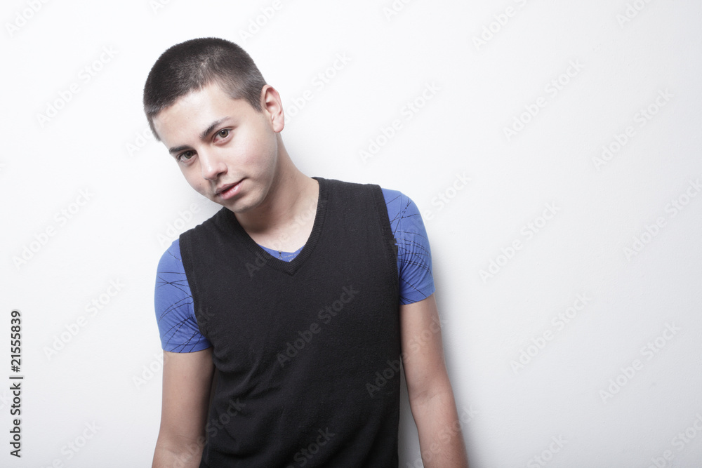 Man posing on a white wall