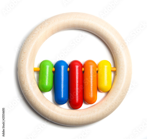 Circular wooden toy with colourful rattle pieces photo