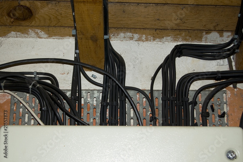 Black electrical cables on an old wall
