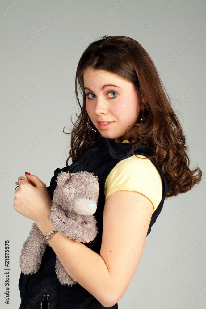 A pretty girl with a teddy bear. A pretty girl with a teddy bear.