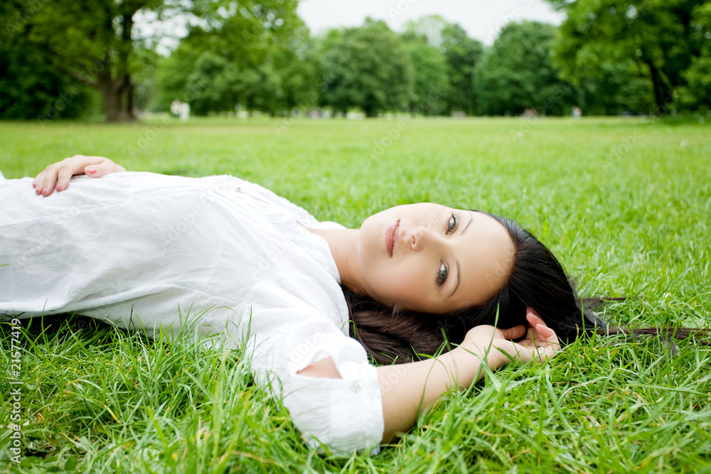 Beautiful woman laying on grass Beautiful woman laying on grass