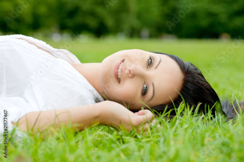 POrtrait of sexy woman laying on grass