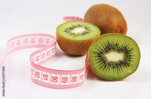 Kiwi fruit with tape measure isolated on white background