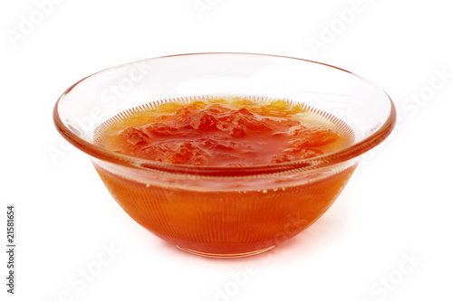 Cup of apricot marmalade on white background