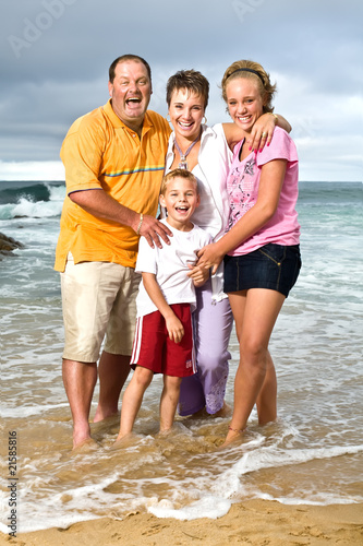 Happy family at the beach photo