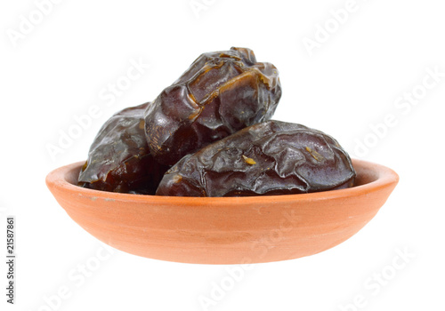 Medjool dates in a terra cotta dish