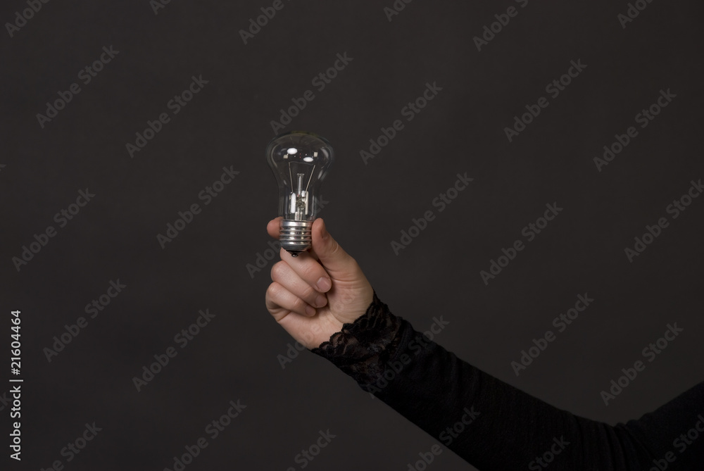 Woman hand with electric bulb