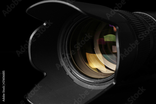 Close-up of a camera telephoto lens in a black background