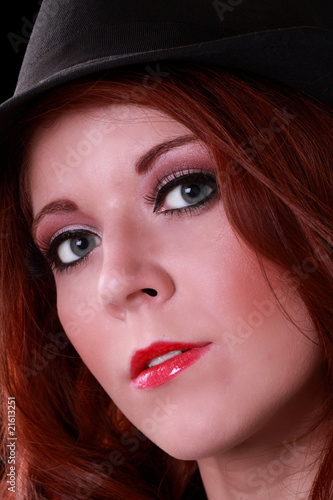 Attractive redhead young woman in black hat