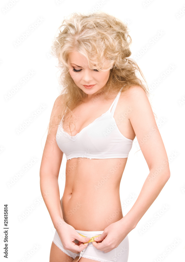 Obraz premium young beautiful woman with measure tape