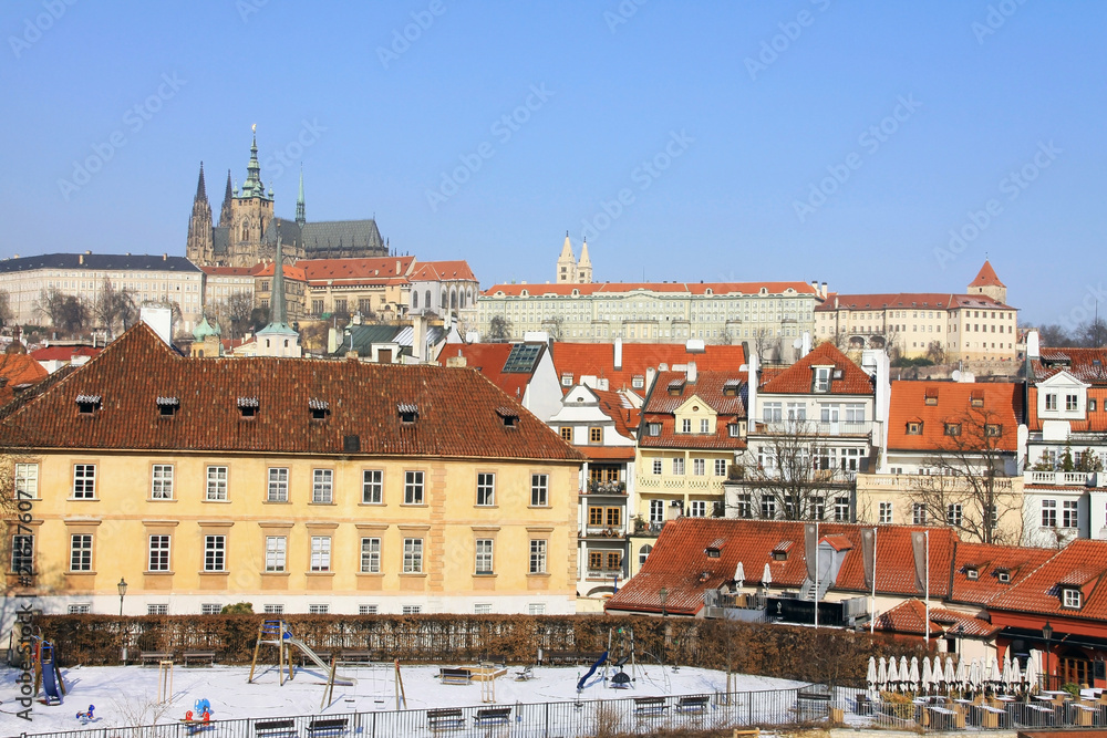 The snowy Prague gothic Castle above the River Vltava