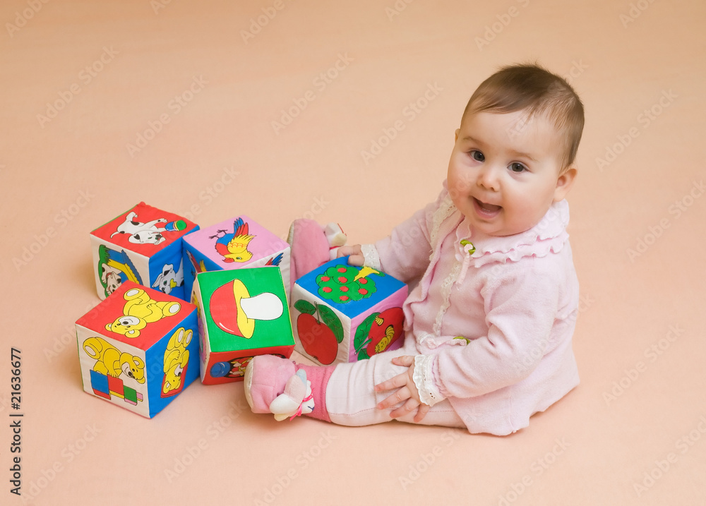 Happy baby girl played with color blocks