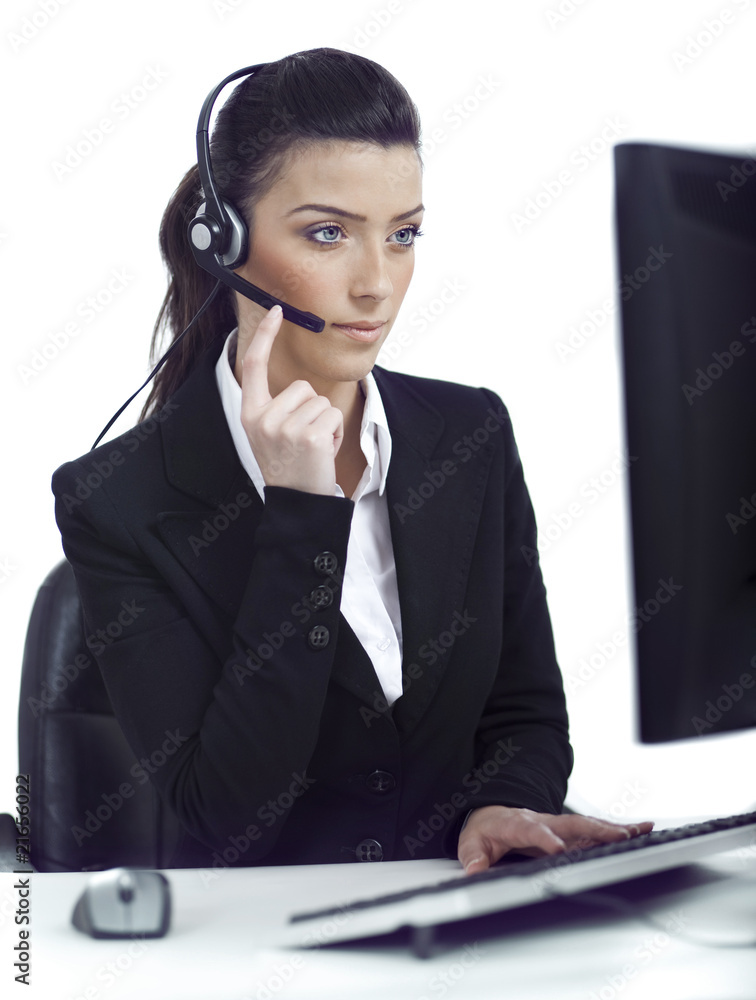 Busy woman seriously hearing the customer talk in headset Busy woman seriously hearing the customer talk in headset