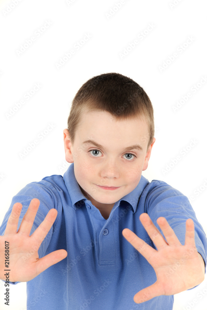 Portrait of young boy waving hands in front of him Portrait of young boy waving hands in front of him
