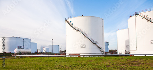 white tanks for petrol and oil in tank farm with blue sky photo