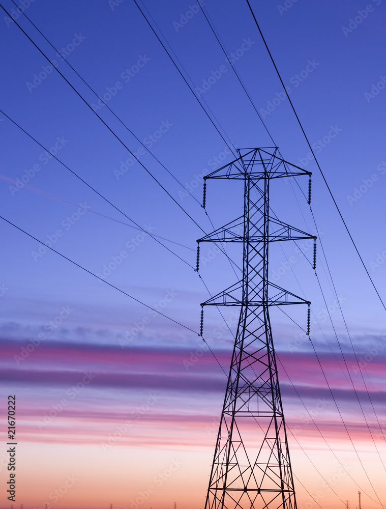 Fototapeta premium Electric power transmission station lines at Sunset