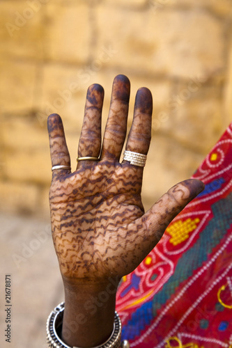 indian woman with traditional henna painted hand
