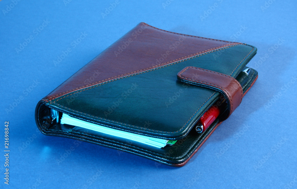 Closed leather office organizer on blue Closed leather office organizer on blue