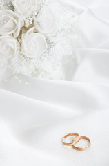 The wedding rings and a bouquet of the bride