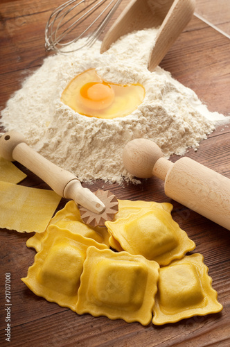 italian ravioli homemade with flour and rollin pin photo